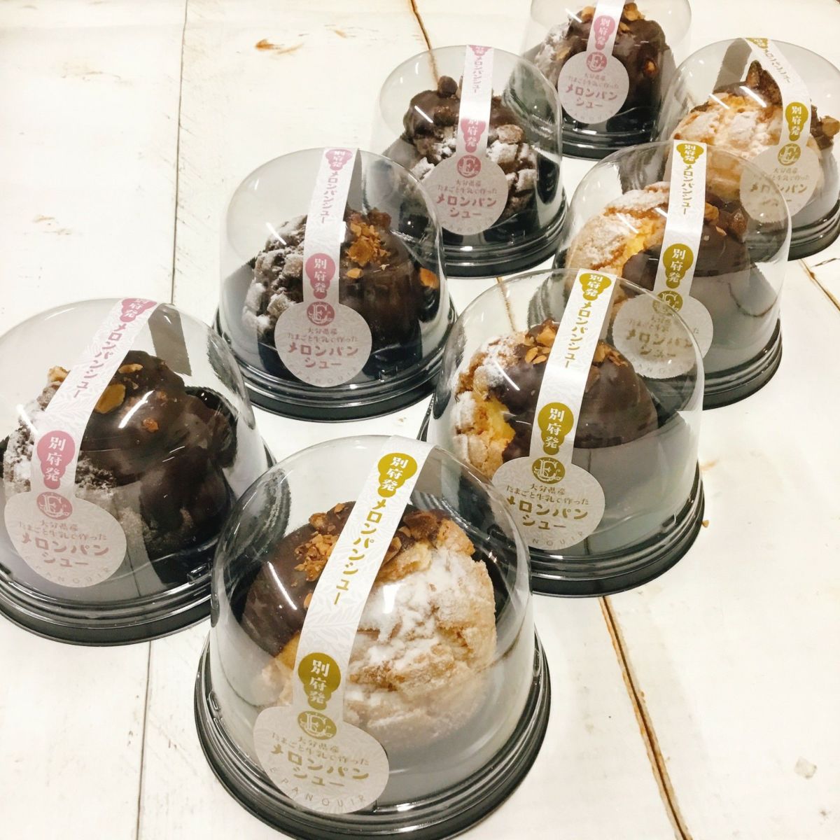 メロンパン生地（バニラ＆チョコ）でシュークリームを包んだ「メロンパンシュー 8個入」が、容器にきれいに並べられた内容量画像。サクサク生地と濃厚クリームが夢のマッチング。