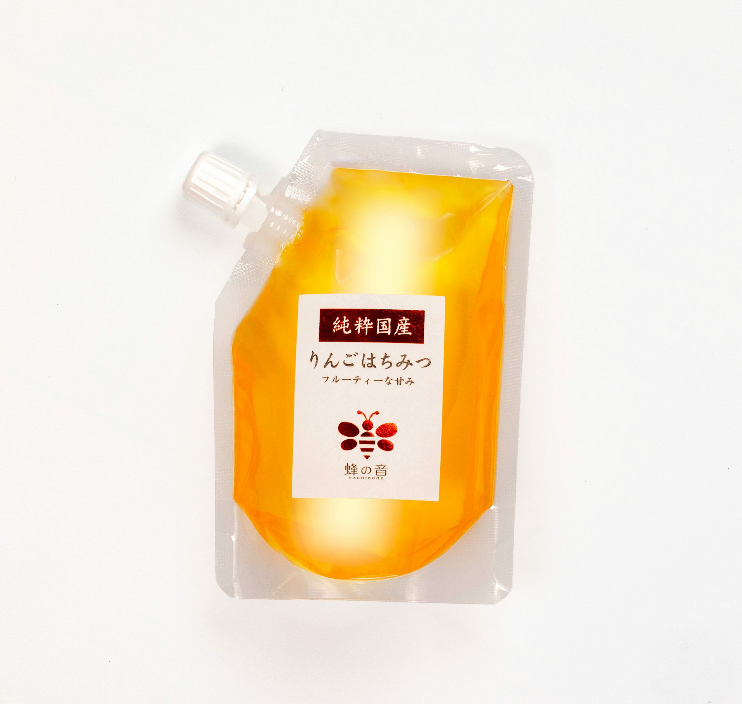 りんごの花を蜜源とした「国産りんごはちみつ」の画像。やや濃いめの黄色で、りんごの優しい甘さとほのかな酸味、フローラルな芳香が特徴の国産はちみつ。