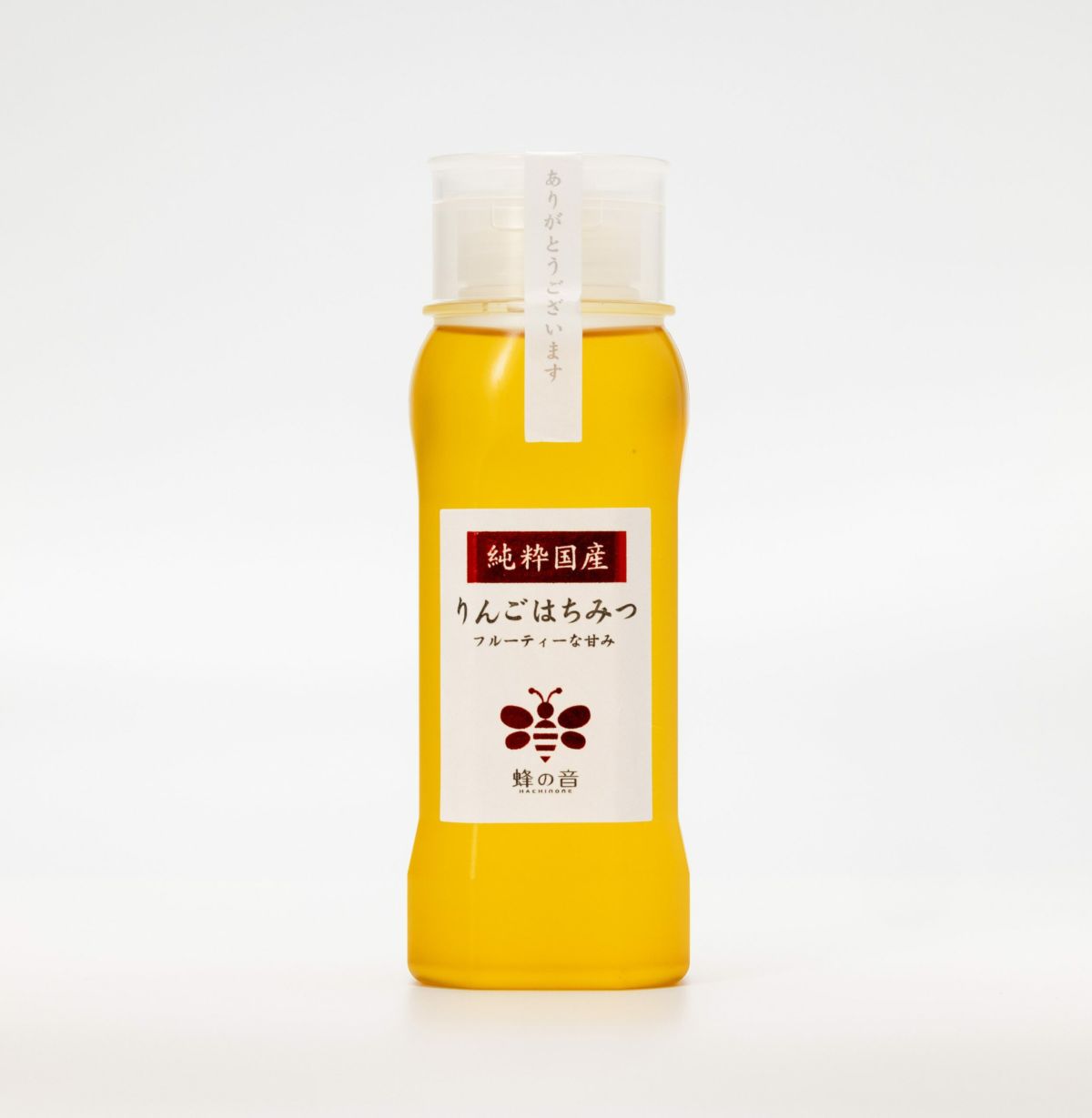 りんごの花を蜜源とした「国産りんごはちみつ」の画像。やや濃いめの黄色で、りんごの優しい甘さとほのかな酸味、フローラルな芳香が特徴の国産はちみつ。