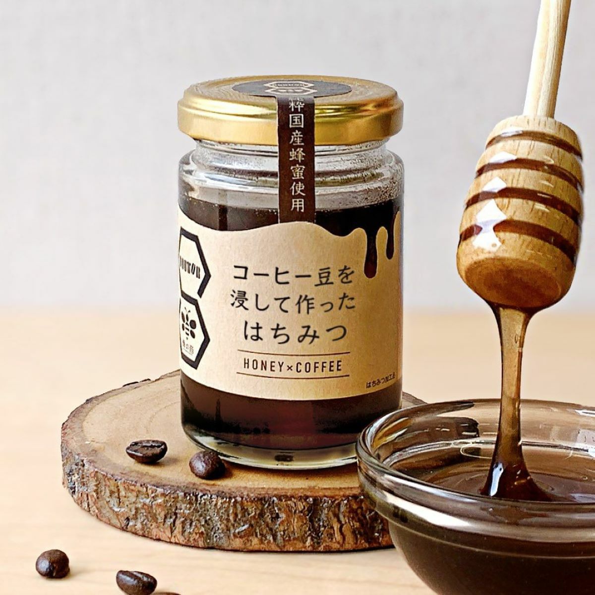 「DOUTOR(ドトール)」と「蜂の音」のコラボ商品である「コーヒー豆を浸したはちみつ」をハニーディッパーですくっている画像。厳選した国産蜂蜜とコーヒー豆の香りが一体となった新感覚の甘さ。